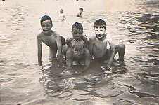 John, Colin and Mark Weightman with
                          Arthur Collins at front in Winn's Common
                          paddling pool c.1949. Photo: Colin Weightman